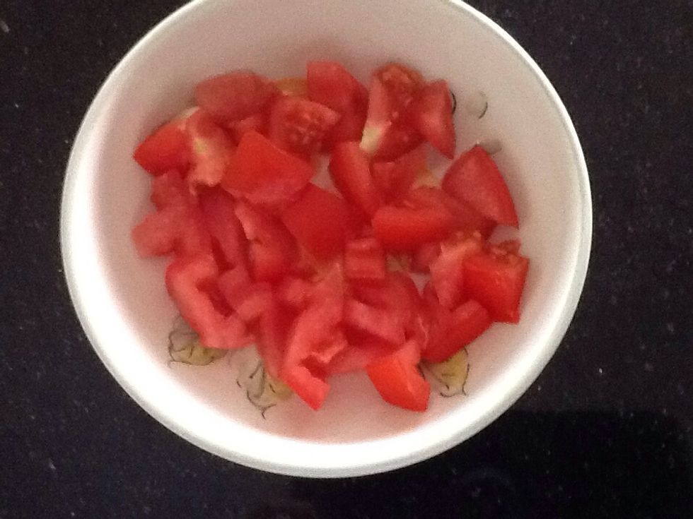 Use one whole tomato, chop it up and place it in a bowl.