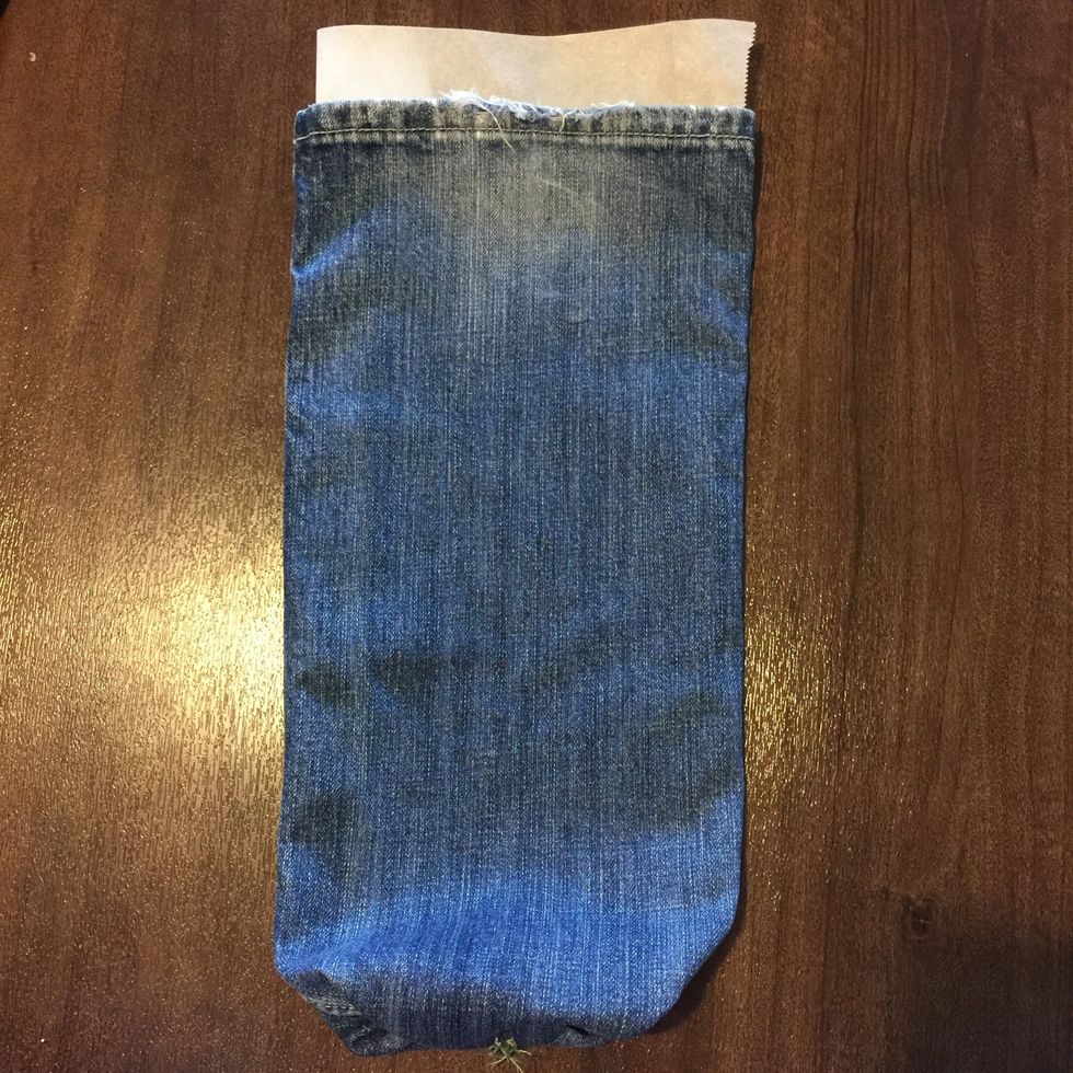 Use parchment paper to cover the insides so that once you start painting, it won't bleed through. Make sure entire length and width of pouch had parchment paper under it.