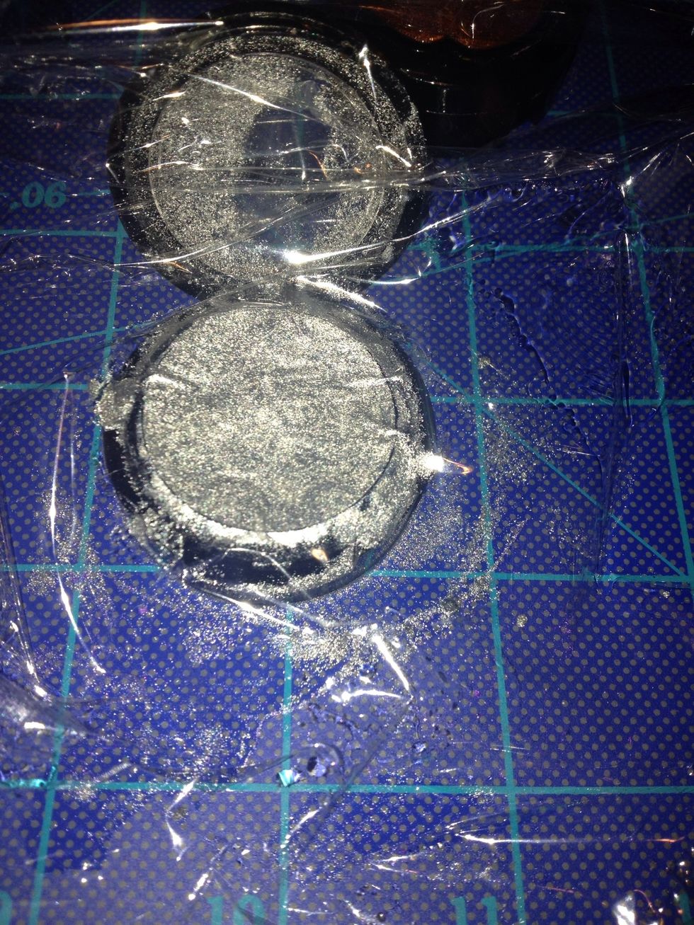 Use plastic wrap and your finger to press down and even out in container