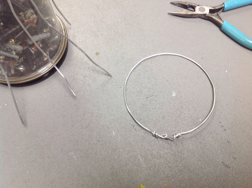 Use pliers to twist the wire around until it is secure.