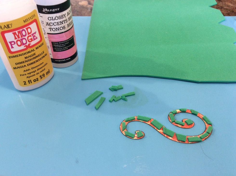 Use pop dots, or foam tape to raise the layer. I often use kids colored craft foam. I use glossy accents or modge podge to glue everything.