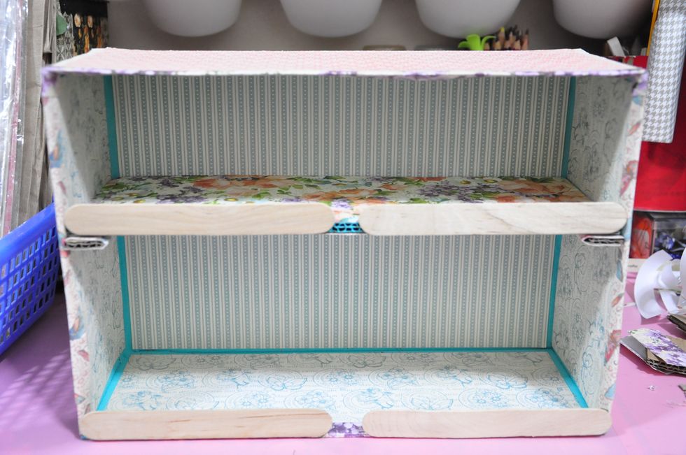 Use popsicle sticks or similar to adhere the folded strip of paper to.