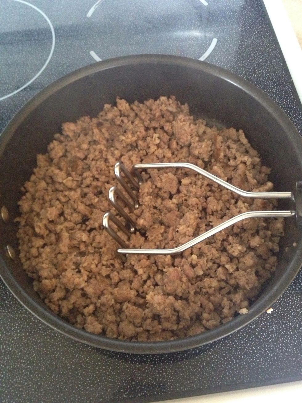 Use potato masher to get sausage into small crumbs.