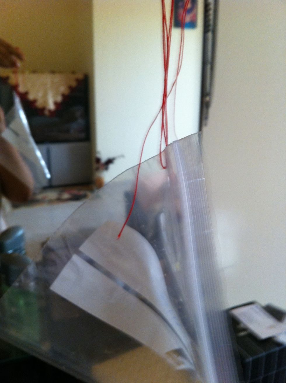 Use ribbon or a string and move it trough the hole