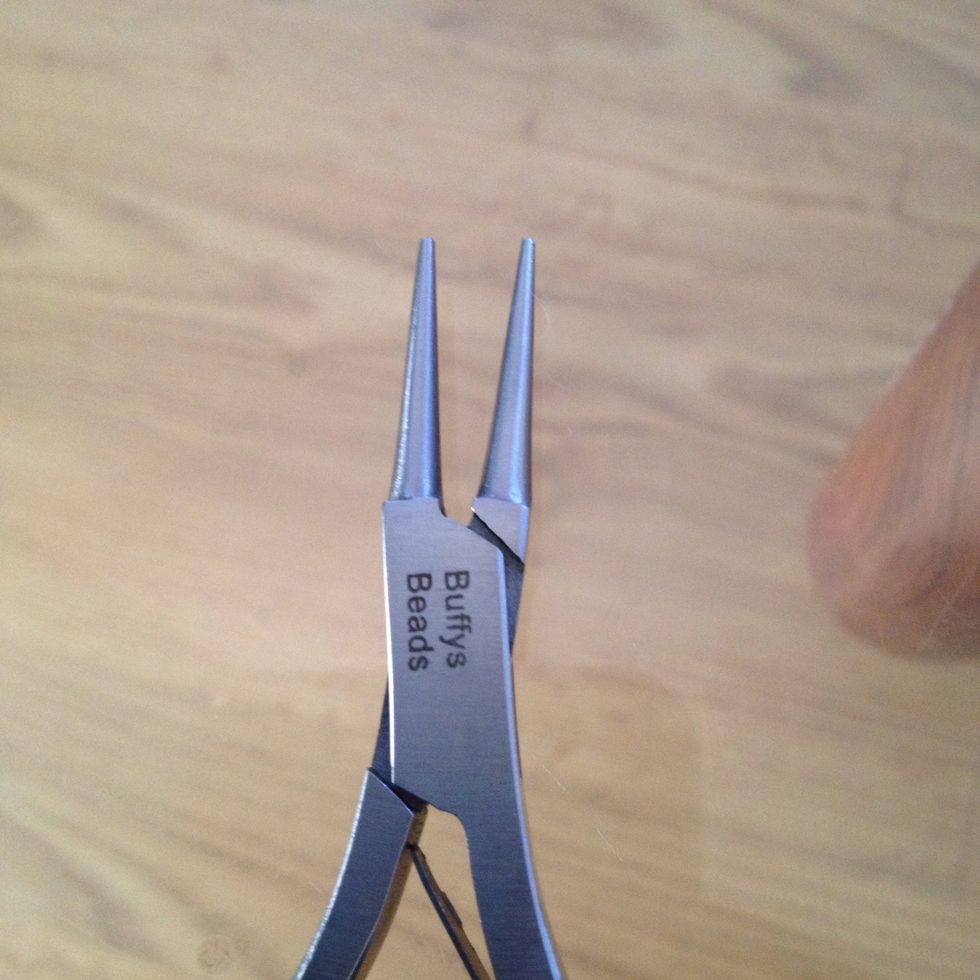 Use round nosed pliers to shape top off rod