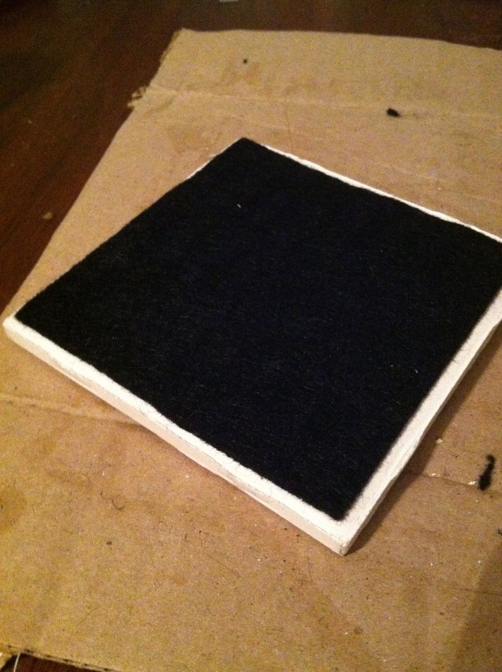 Use rubber cement to adhere the felt to the bottom of each tile. A hot glue gun also works.