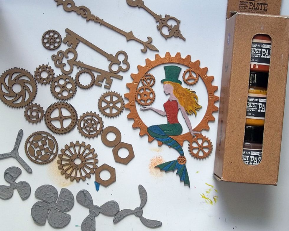 Use Rust Effects Paste on chipboard gears, keys, clock hands & washers/nuts - I layered yellow, red then brown paste. Add Antique Silver Crackle Paste then Rust Effects to the chipboard Propellers.