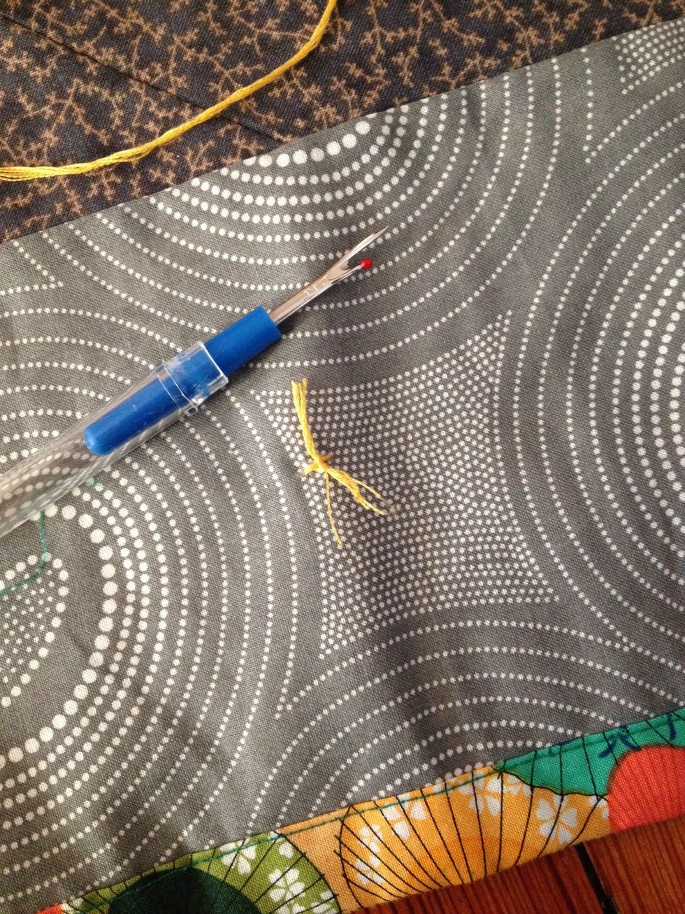 Use scissors (or seem splitter like I did) to trim ends to same length and free your needle with thread for the next one.