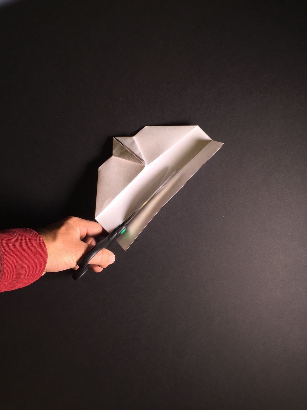 Use scissors to cut along the crease, or moisten the crease to easily tear off the back of the wing.