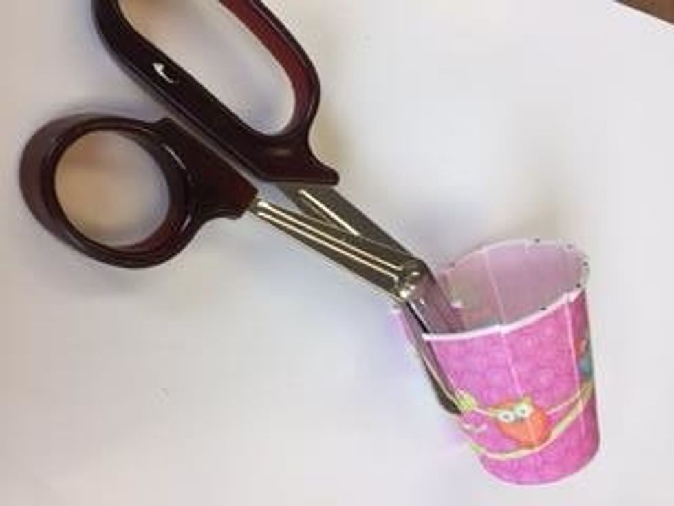 Use scissors to cut an odd number of slits from the top of the cup ALMOST all of the way down to the bottom of the cup.