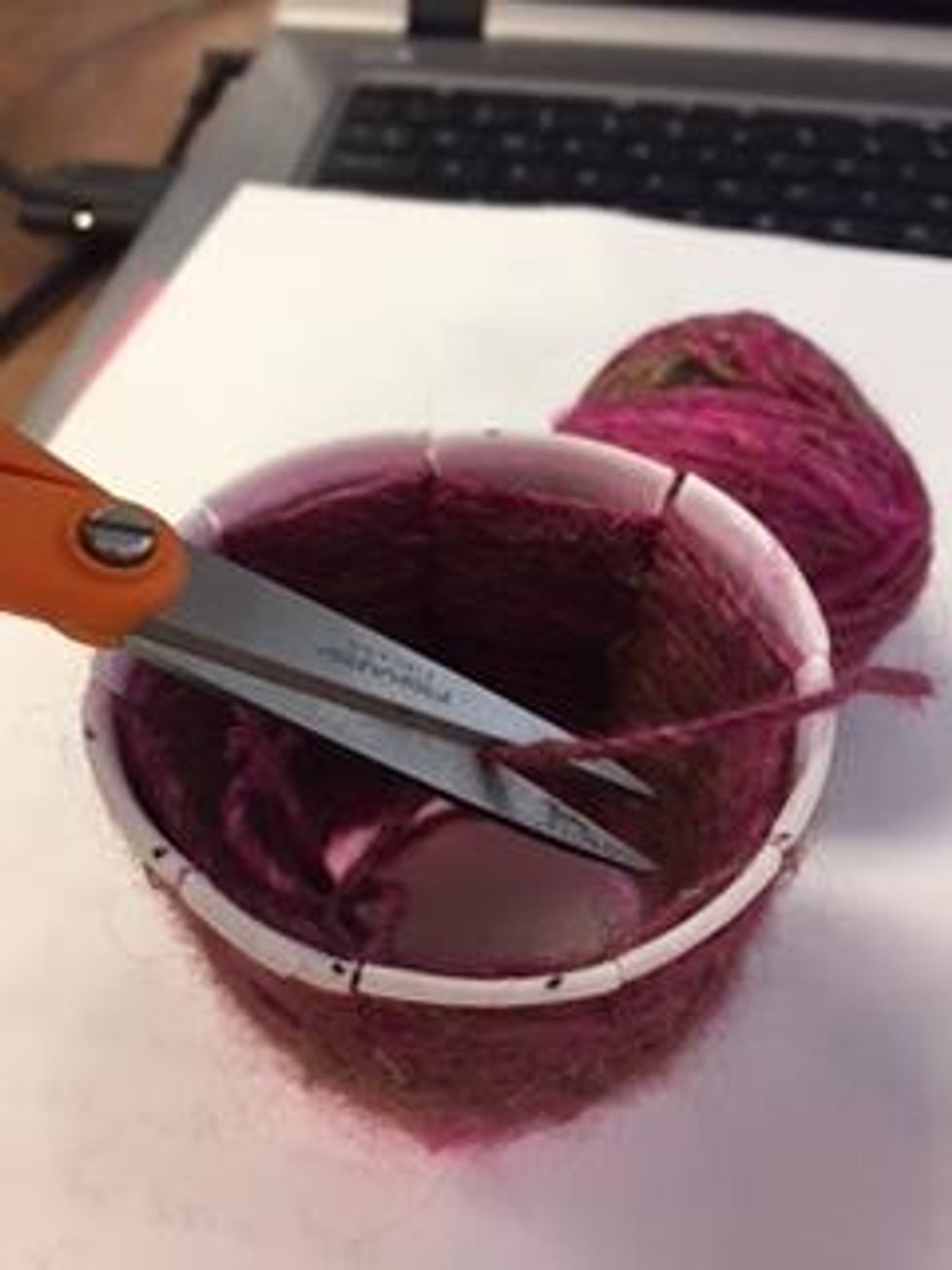 Use scissors to cut the yarn, leaving a short "tail".