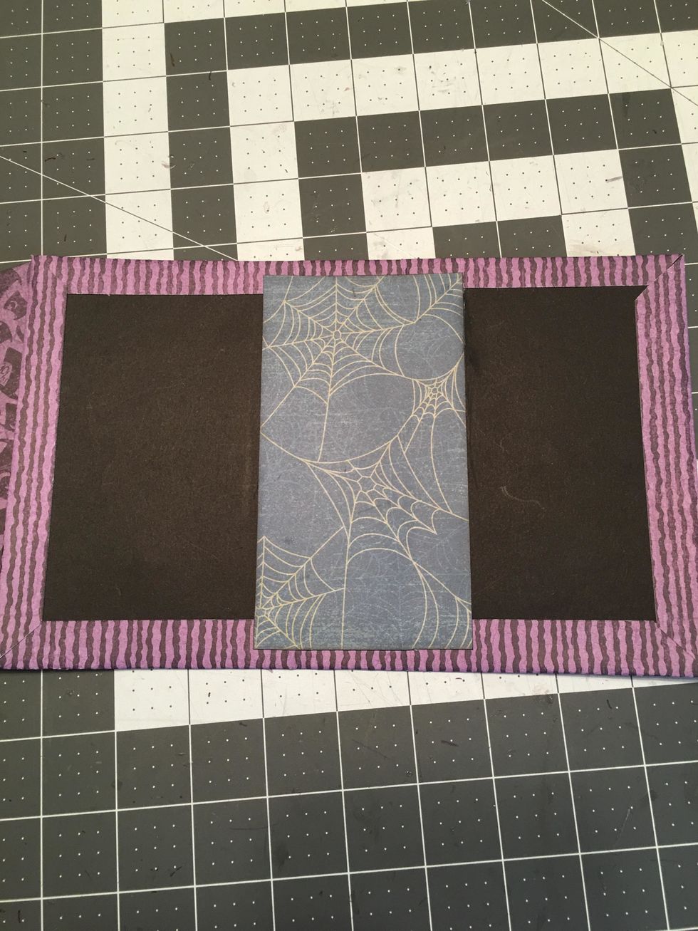 Use scor-tape and attach paper to cover the center spine area inside the cover.