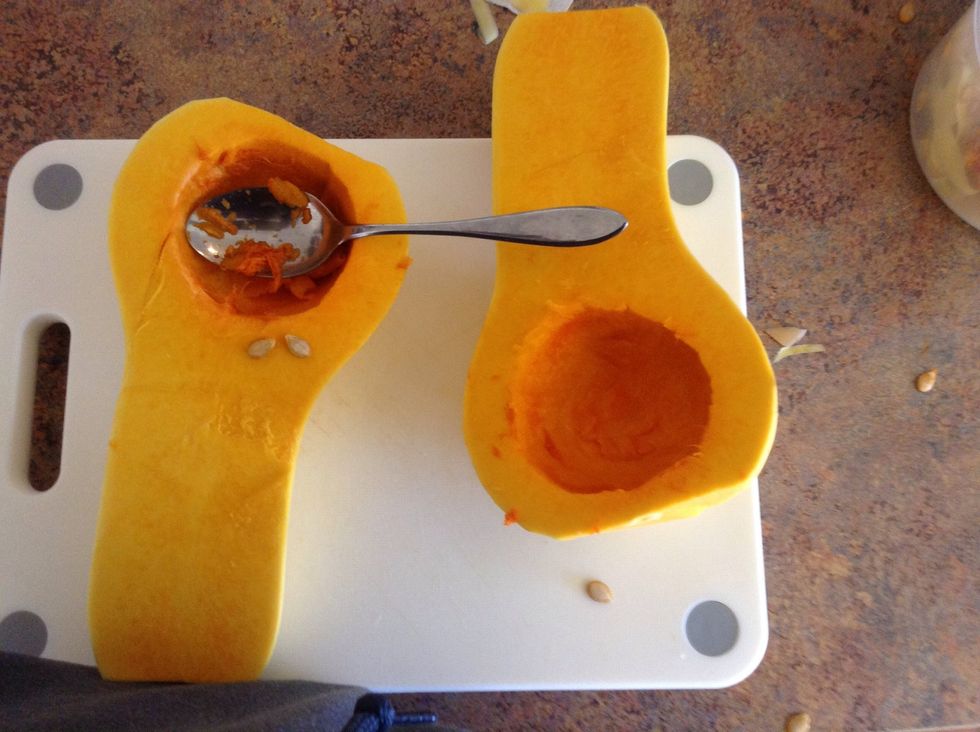 Use spoon to scoop seeds out of squash