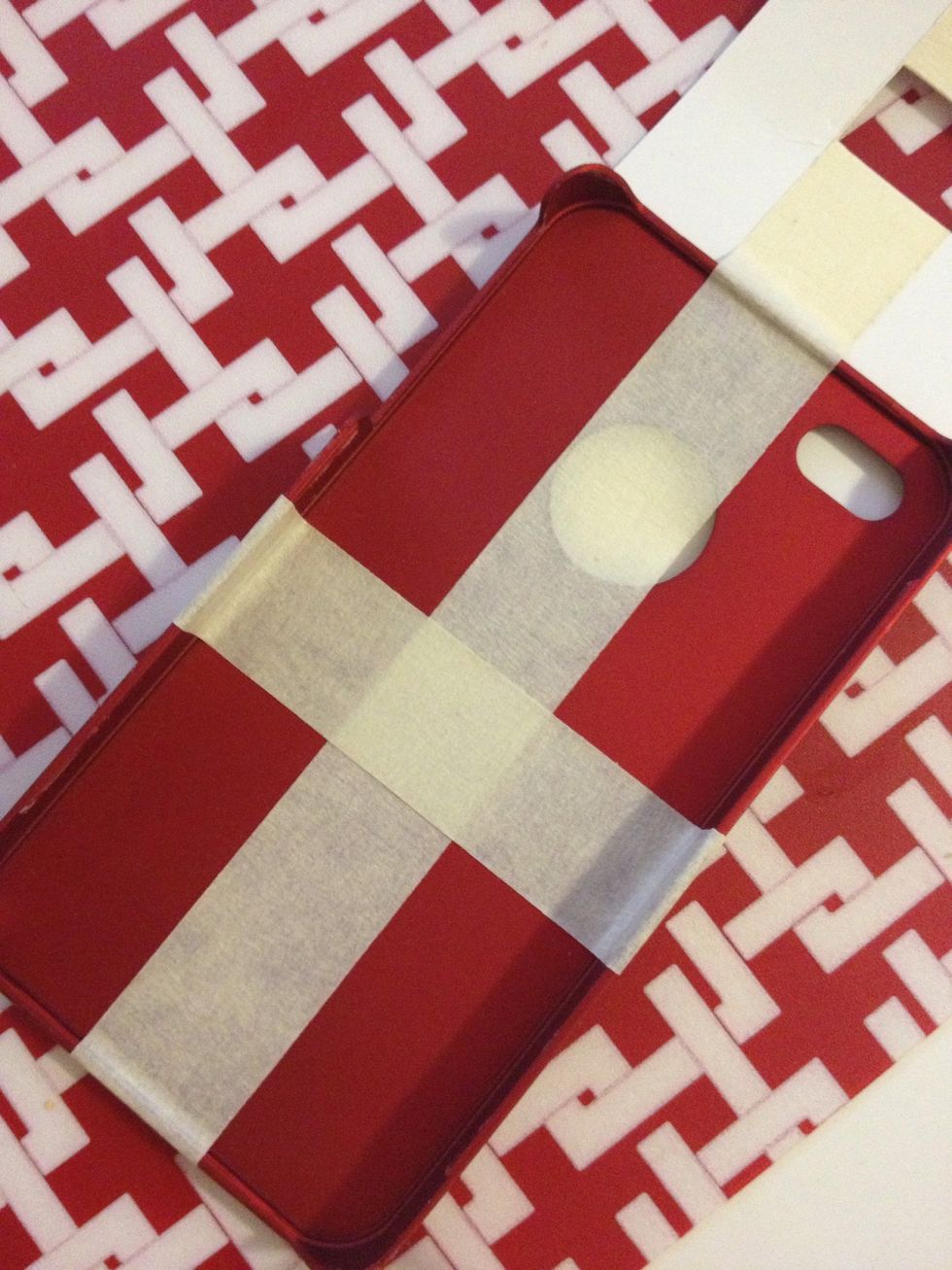 Use tape to adhere a used iPhone case and paper together.