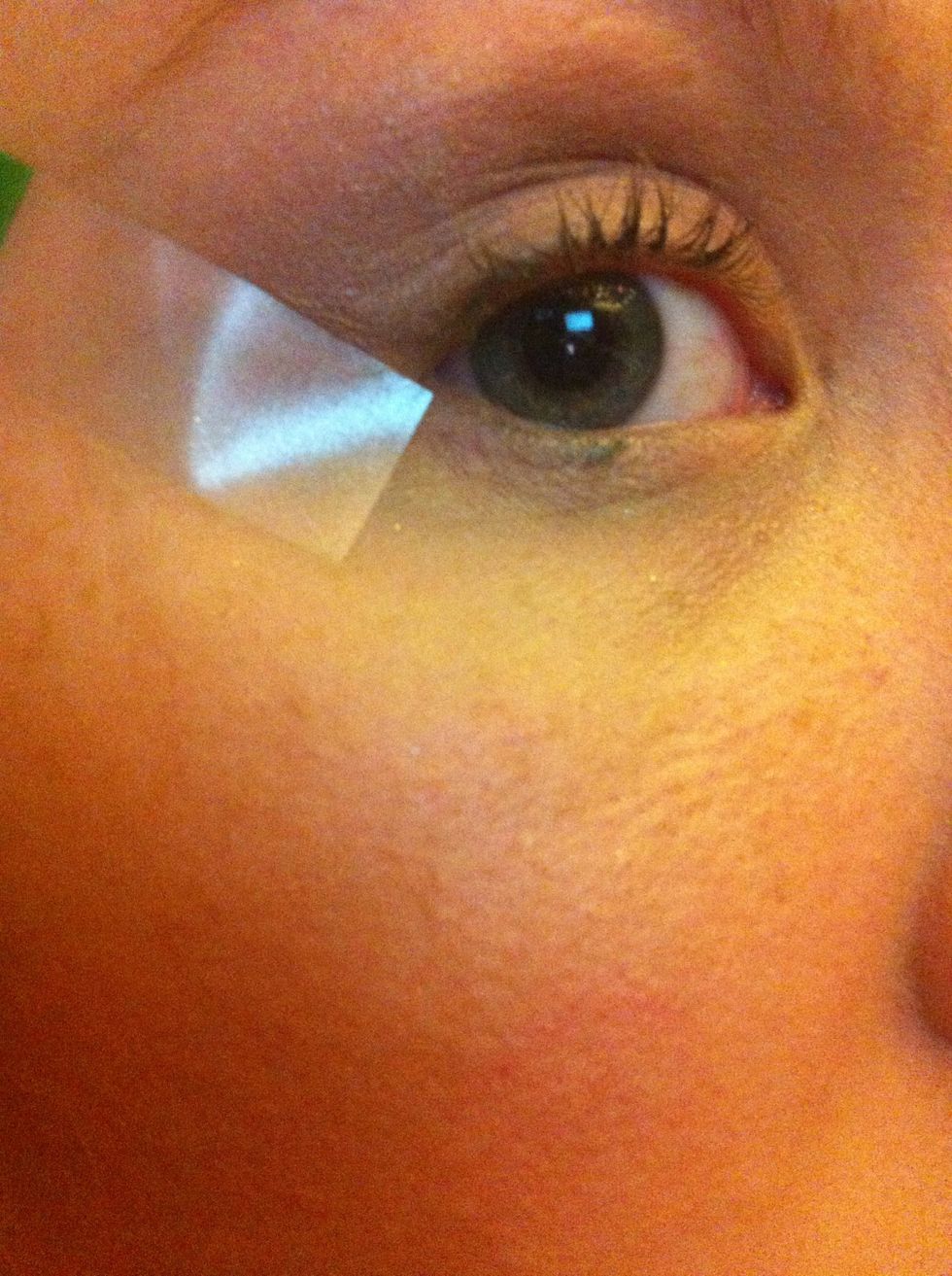 use tape to create a clean line with your shadow, on the angle you want your cat eye to sit. The winged liner will follow the edge of the shadow.