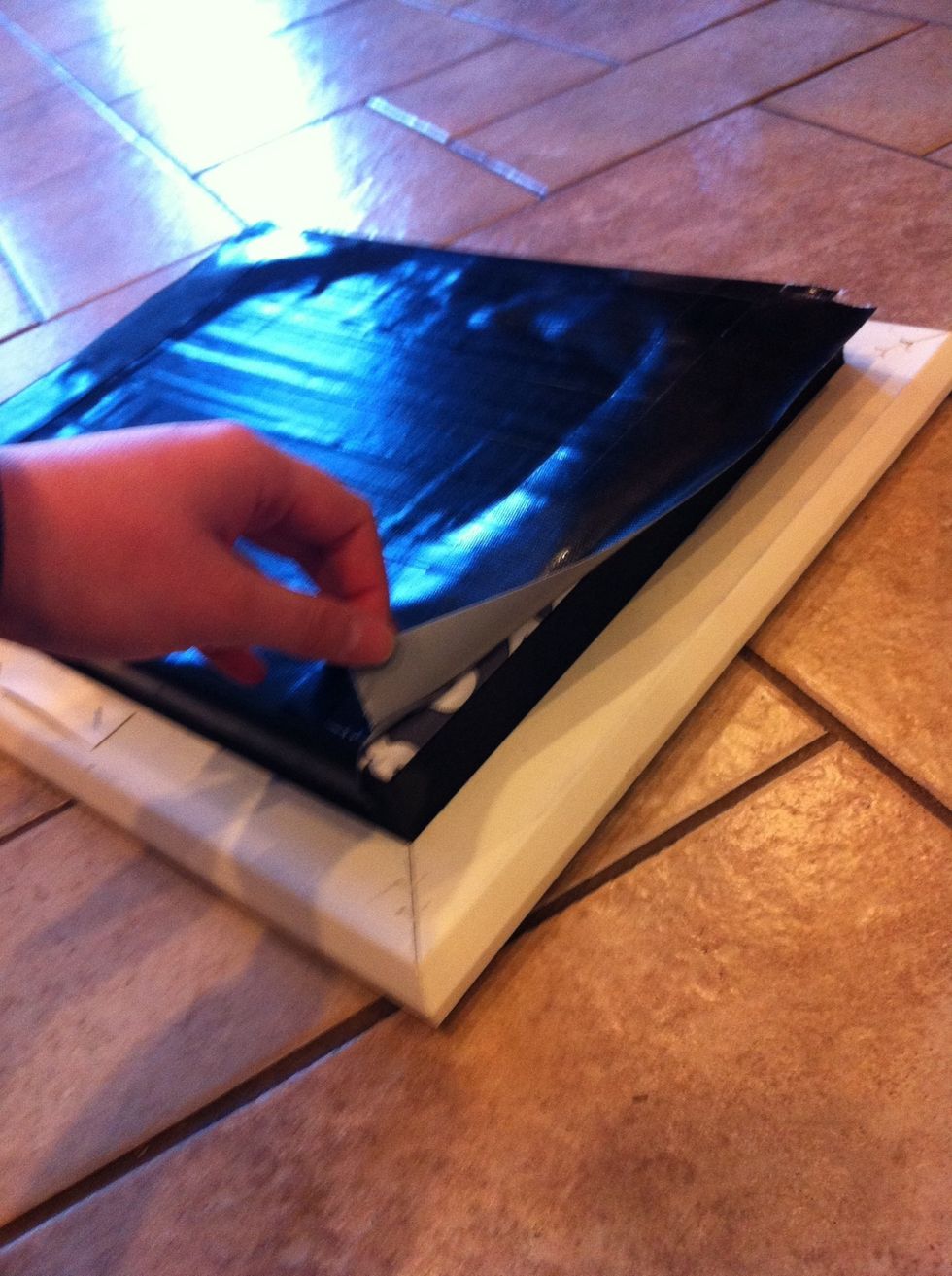 Use tape to secure the fabric covered backboard to to back of the frame