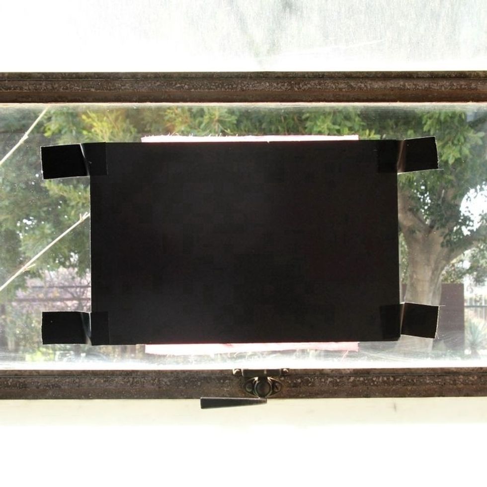 Use tape to secure your project to a sunny window. Be careful not to poke yourself on the straight pins on the back of the board!