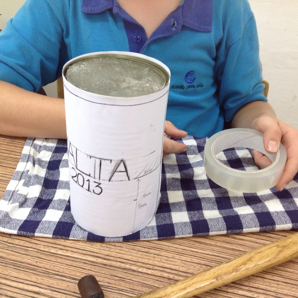 Use tape to stick stencil to the can.