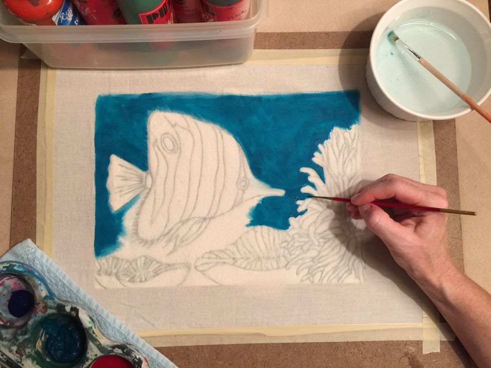 Use tempera paint to paint over the muslin fabric.