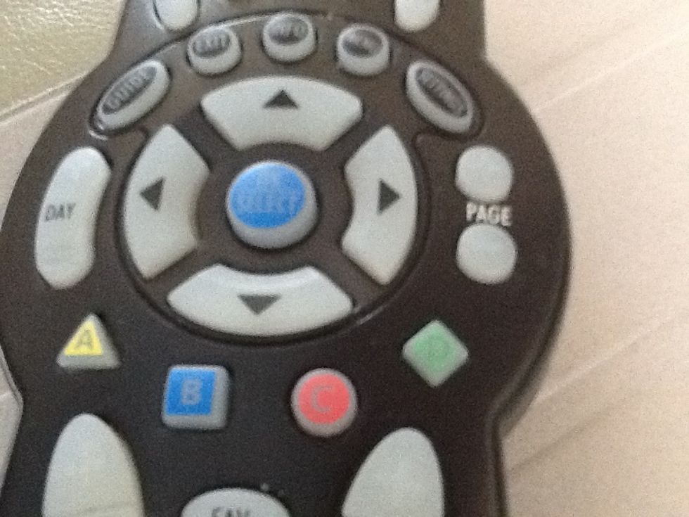 Use the arrows located in the middle of the remote to scroll the guide up and down, locating the show you will record.