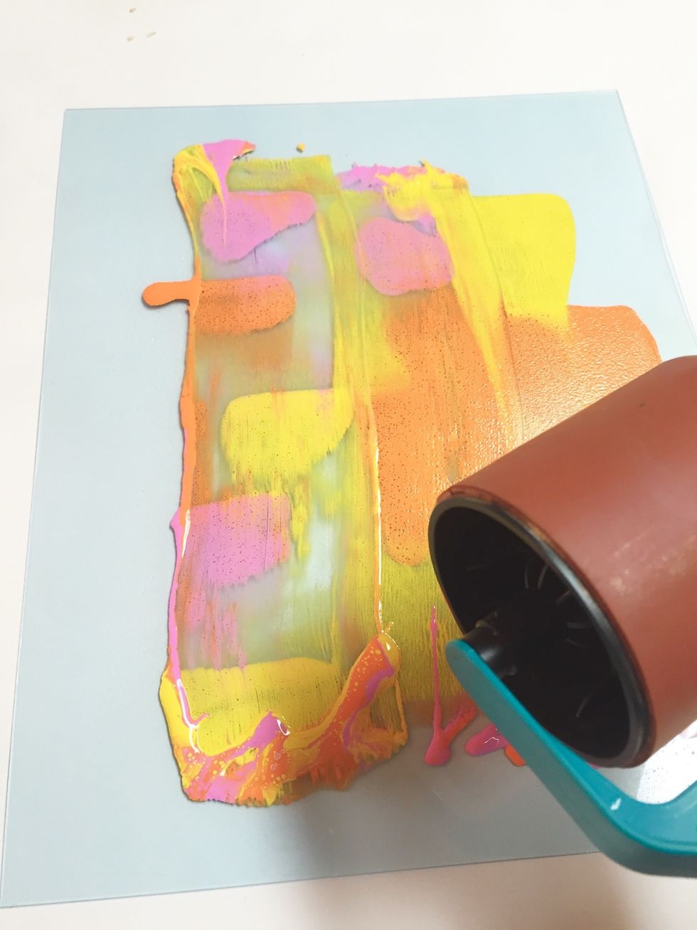 use the art wheel to begin to gently blend inks and spread them over the plate.