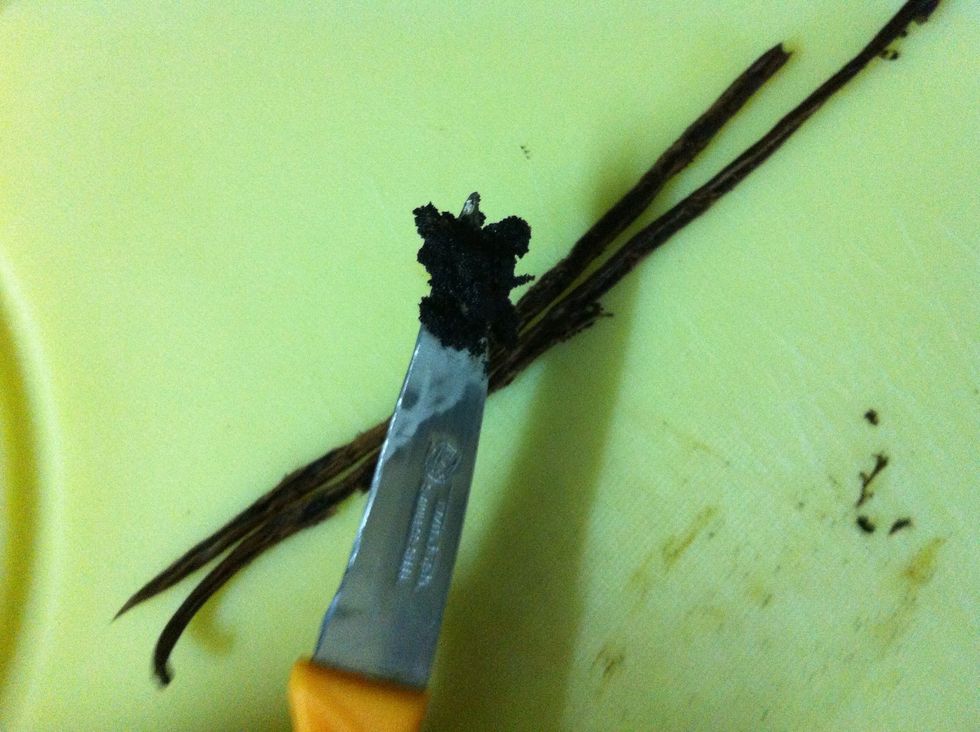 Use the back of a paring or butter knife to scrape out the beans out of the vanilla pod.