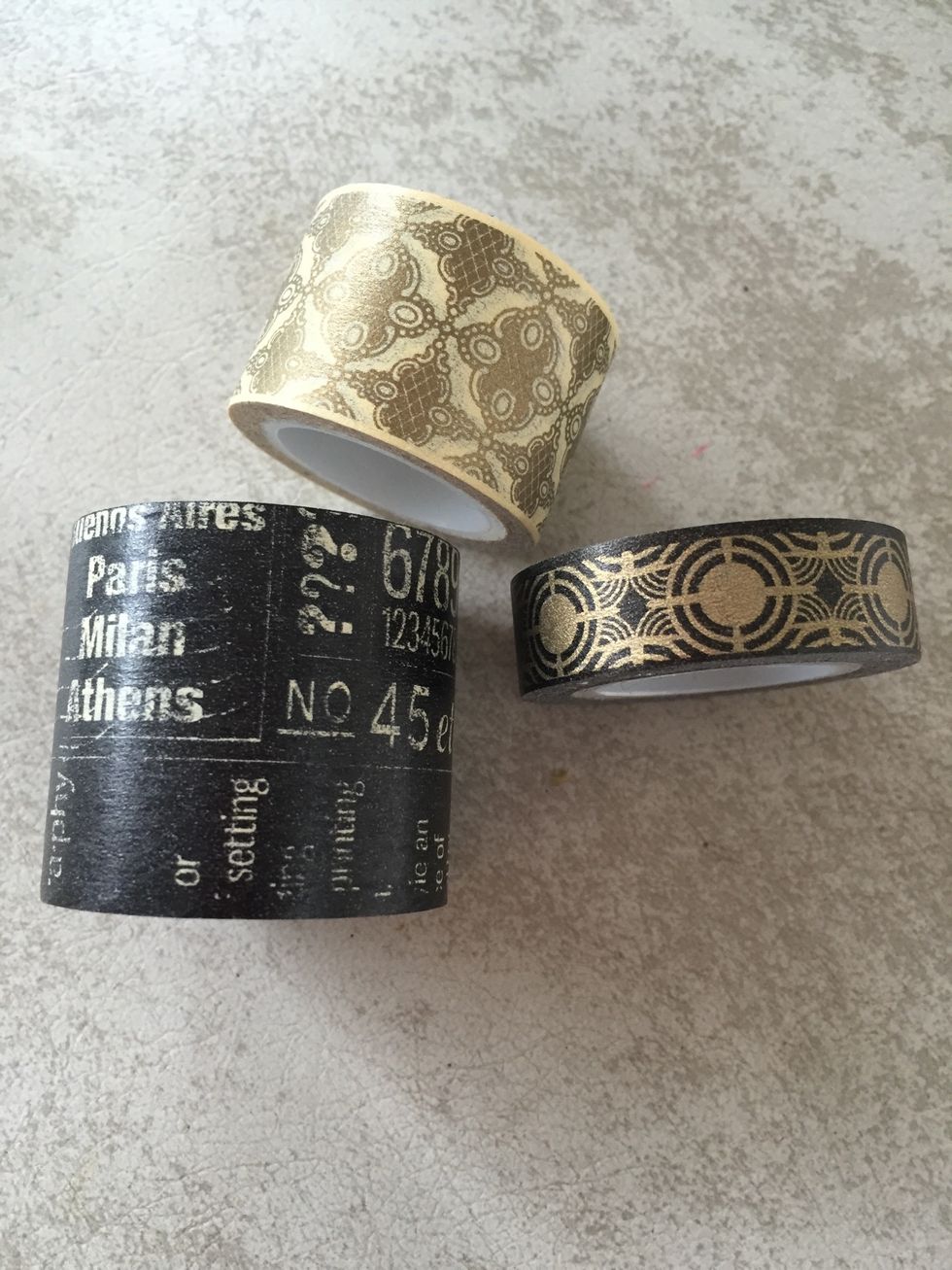 Use the big black washi tape to cover the whole medicine bottle except for the lid. Use the smaller black and gold washi to cover just under the lid. It won't be perfect but that's part of the look!