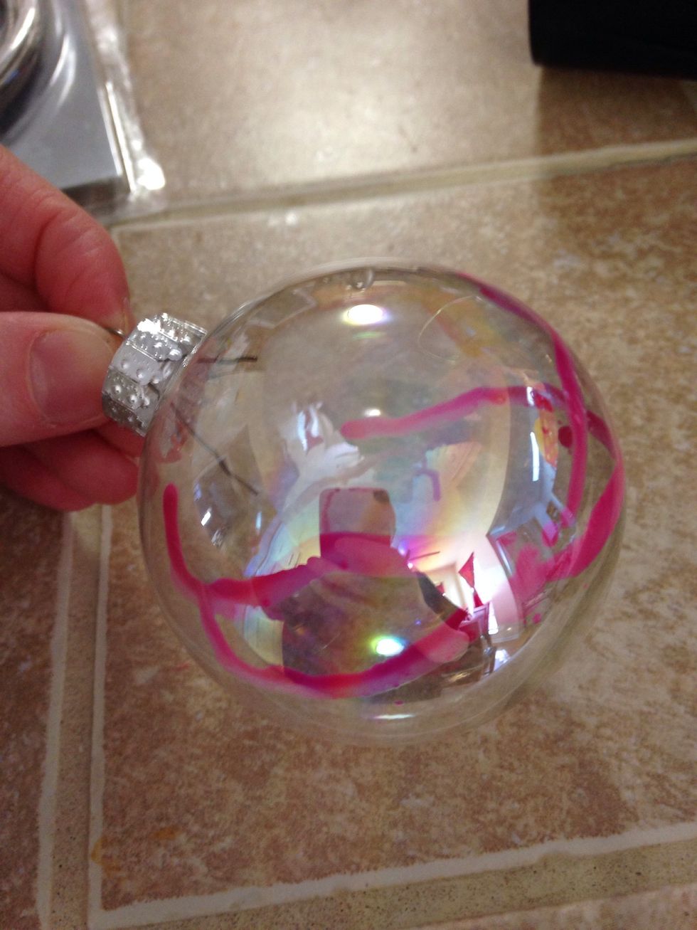 Use the blow dryer to melt the crayons while you slowly rotate the ornament. The ornament can get pretty hot, so watch your fingers.