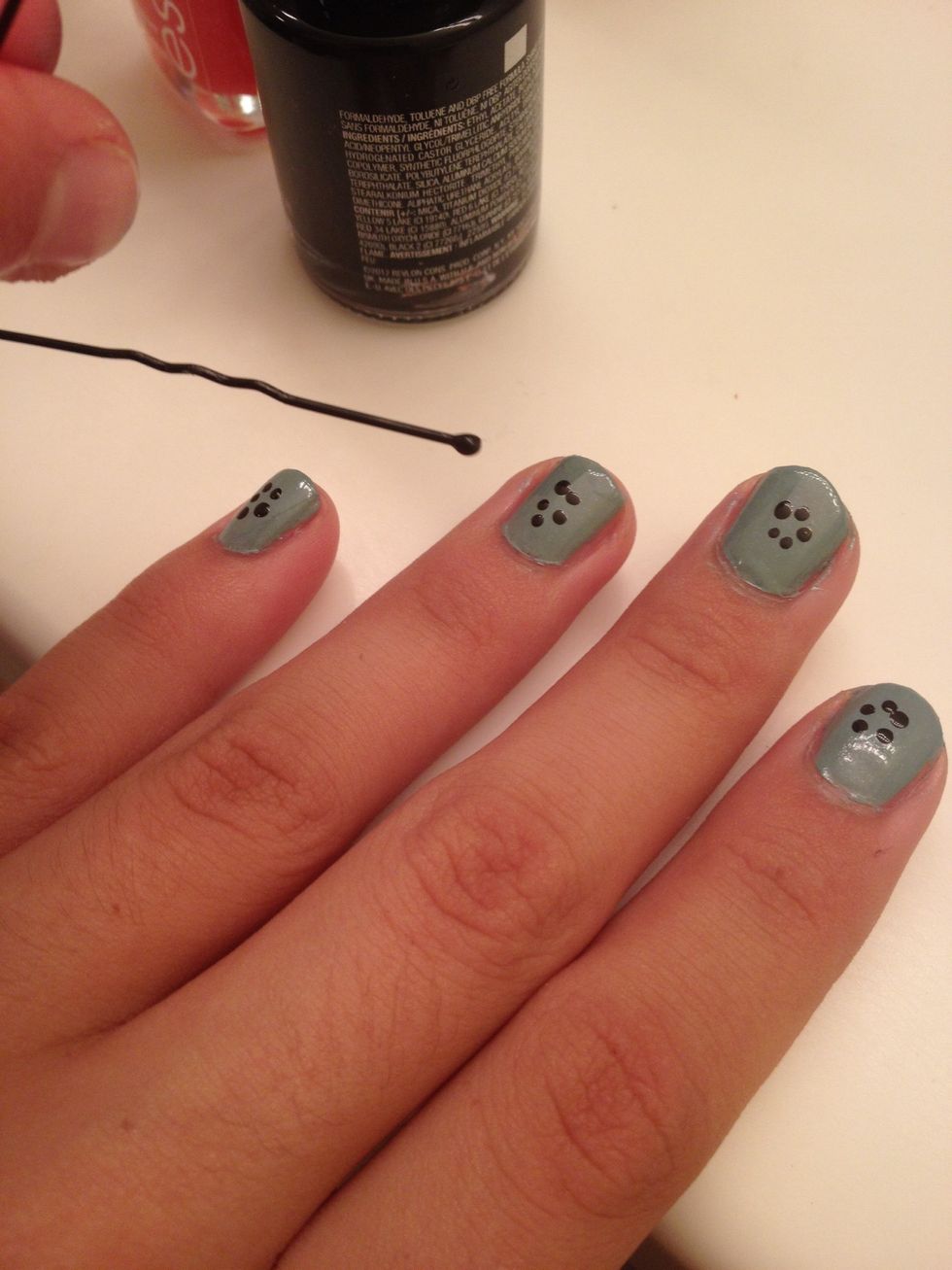 Use the bobby pin to dot 5 dots on your nails in a circle fashion. These are the petals of your flowers.