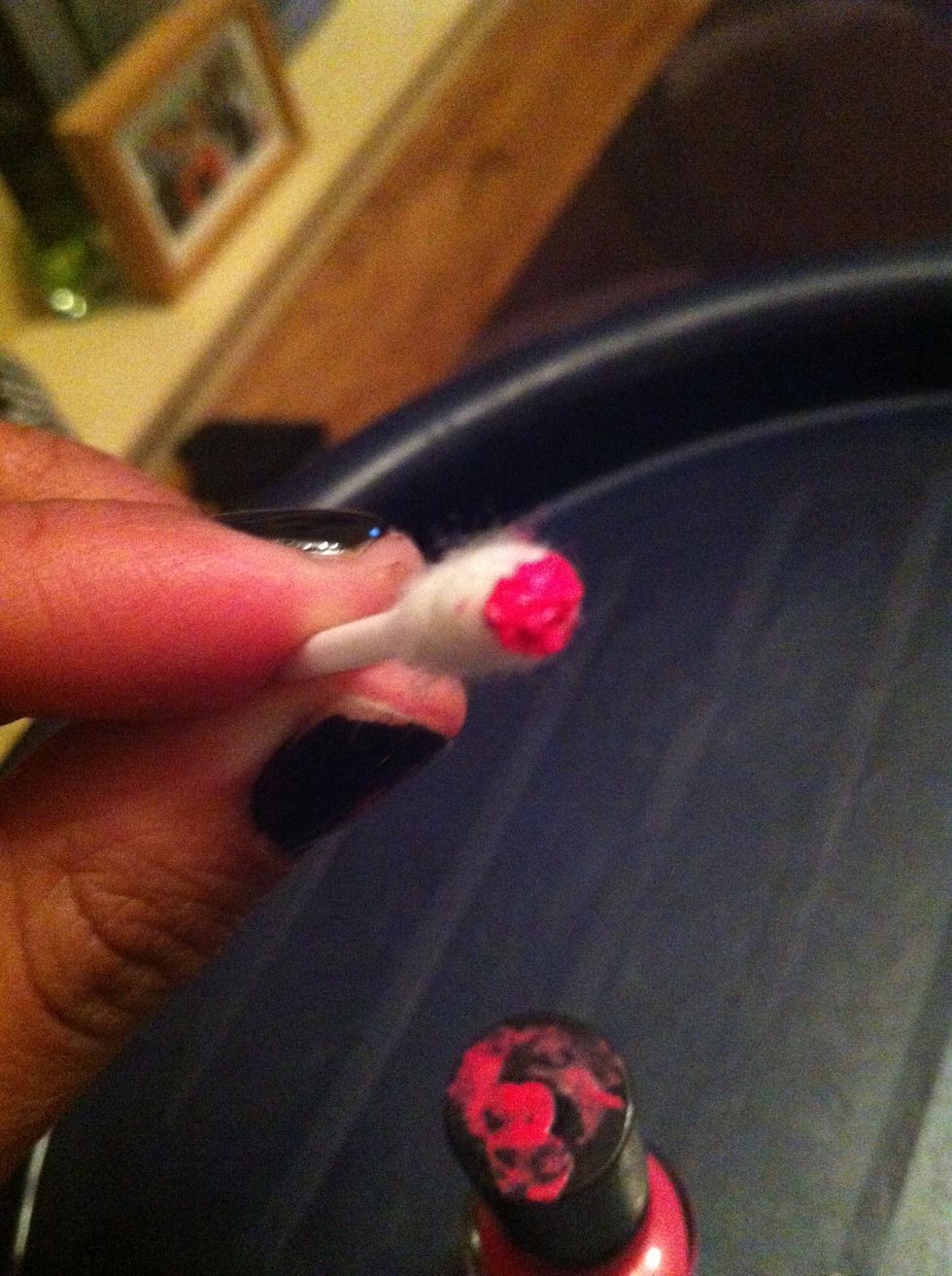 Use the brush from the varnish to lightly wet the cotton bud, you don't want it to be soaked