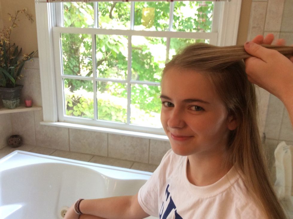 Use the brush to separate a piece of your hair from the middle of your part to your forehead. This is the hair that will be used for the beginning of the braid.