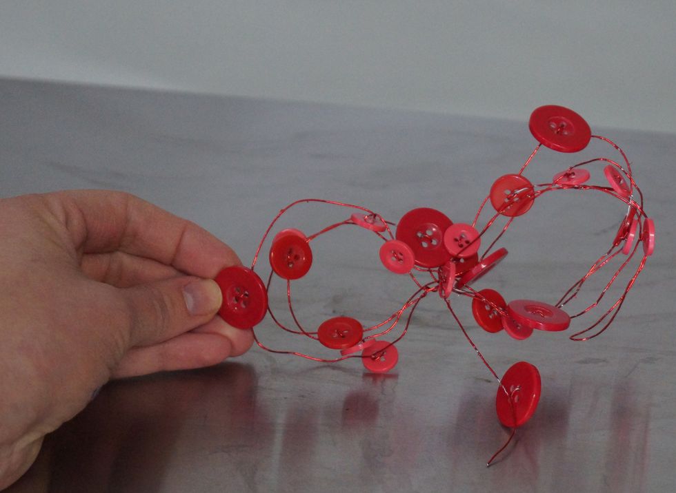 Use the Button Wire and loop in figure eight shapes creating a "bow."