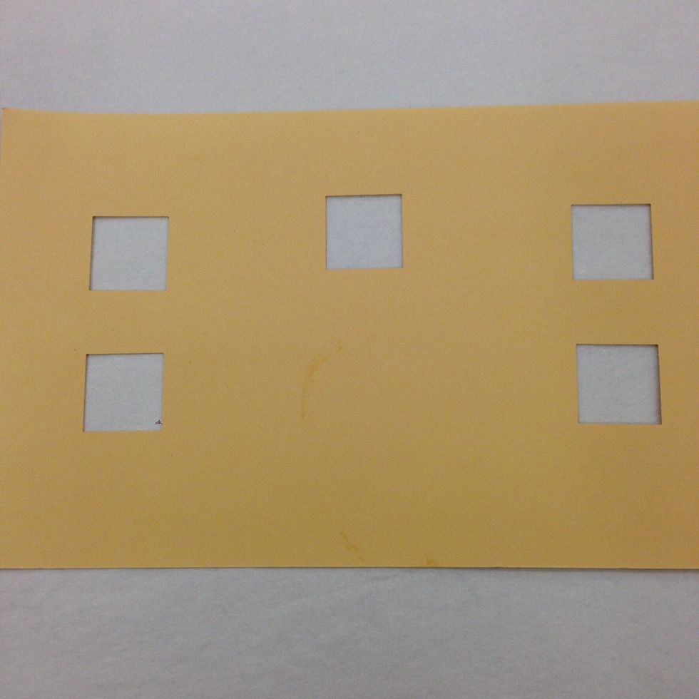 Use the circle or square punch to make window openings in the house. They can be arranged any way you like.