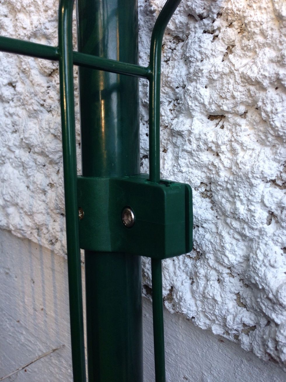 Use the connectors to connect the fence elements to the poles.