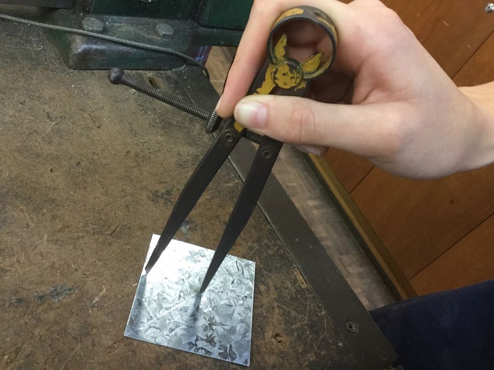 Use the divider to mark a perfect circle on your sheet metal