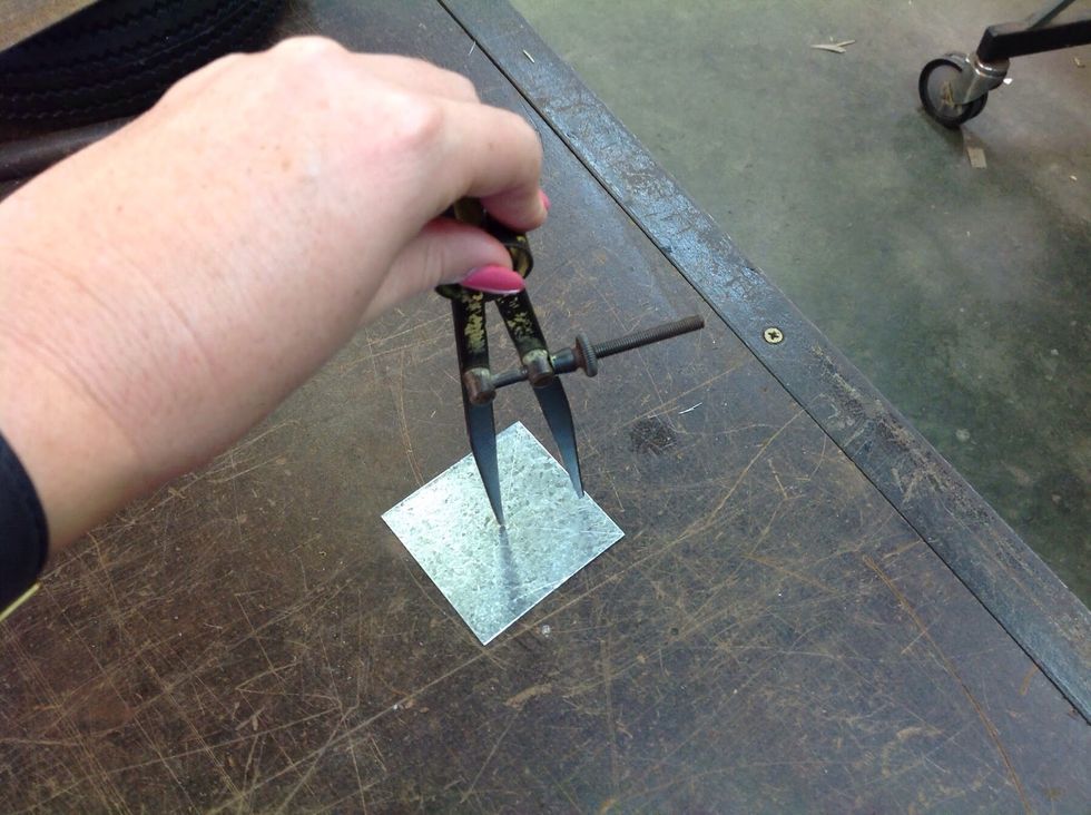 Use the divider with one end in the centre punch mark