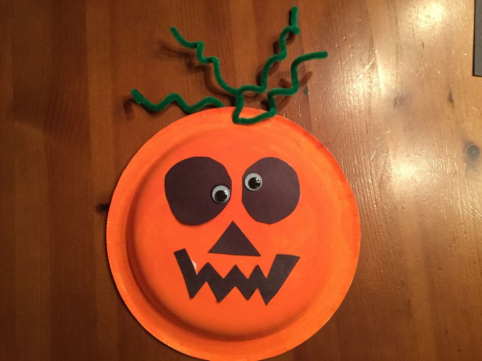 Use the end of the paint brush to twist your pipe cleaners around and make them twirly. Thread the twirly pipe cleaners through the hole and twist them together at the base.