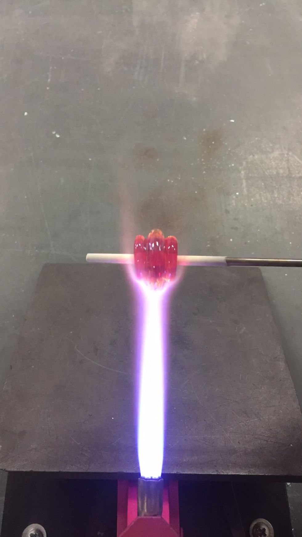 Use the flame to continue melting in the clear rings.