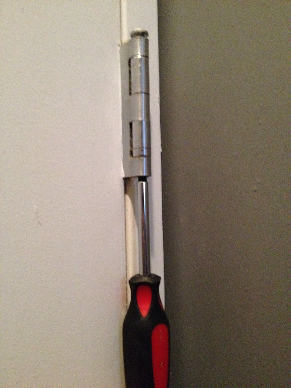 Use the flathead and hammer to tap the bottom of the pin upwards. You can continue to do it this way or place the flathead under the top of the pin. Gently tap until removed.