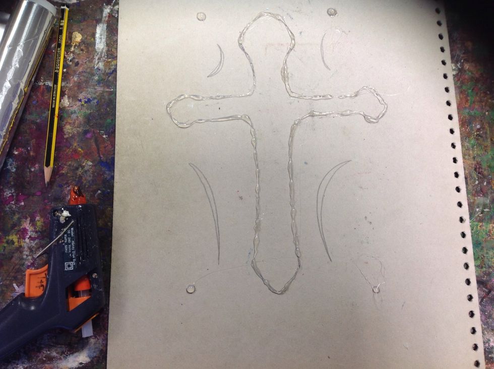 Use the glue gun to go over the design so it is raised