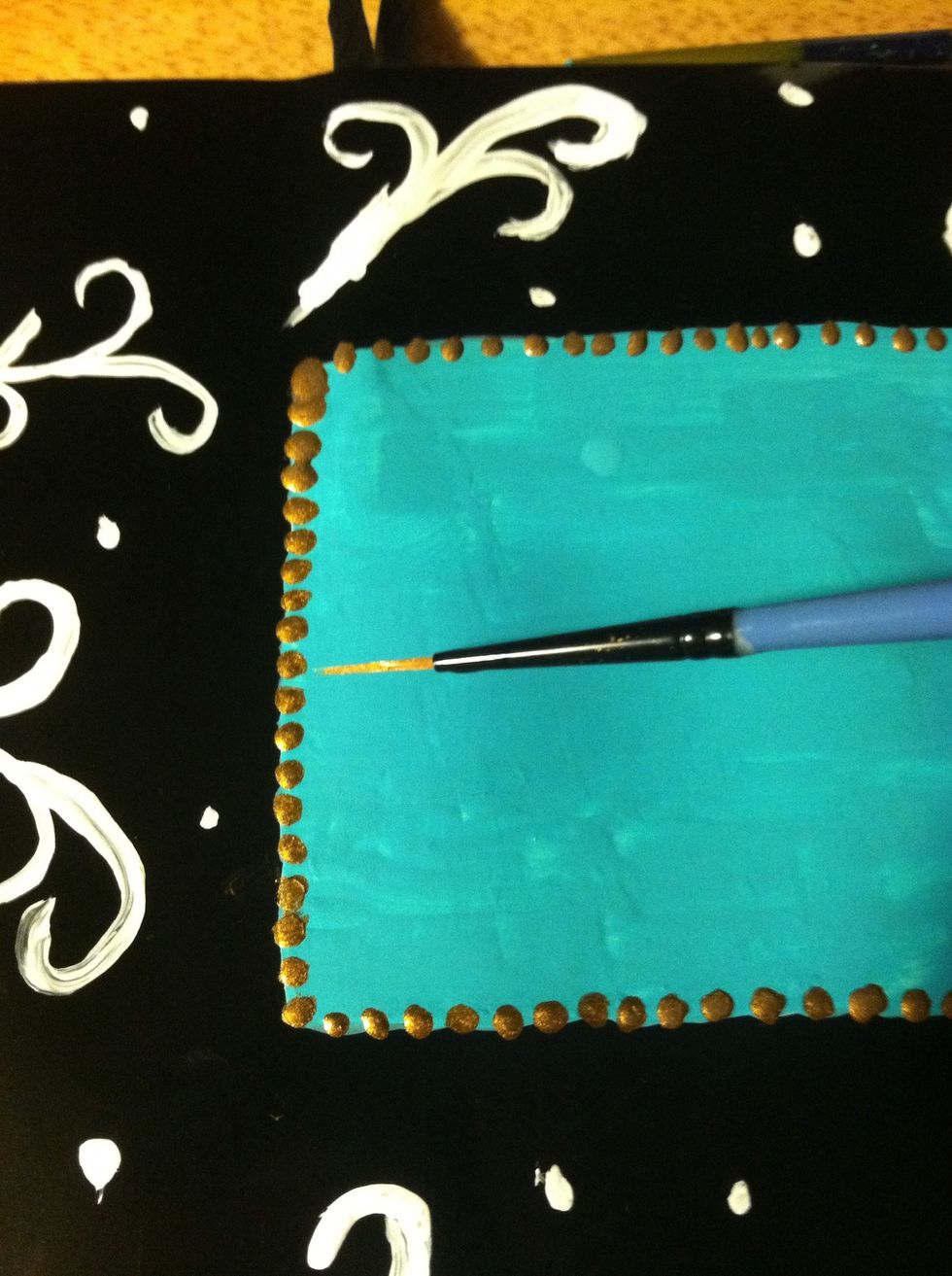 Use the gold paint to place little dots around the square. You could do a solid line too.