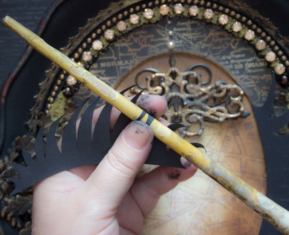 Use the handle of a paintbrush to create attractive curves for the 'feathers':