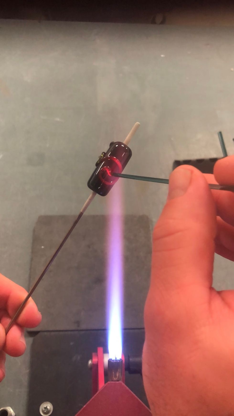 Use the heat of the flame to cleanly terminate each spiral.