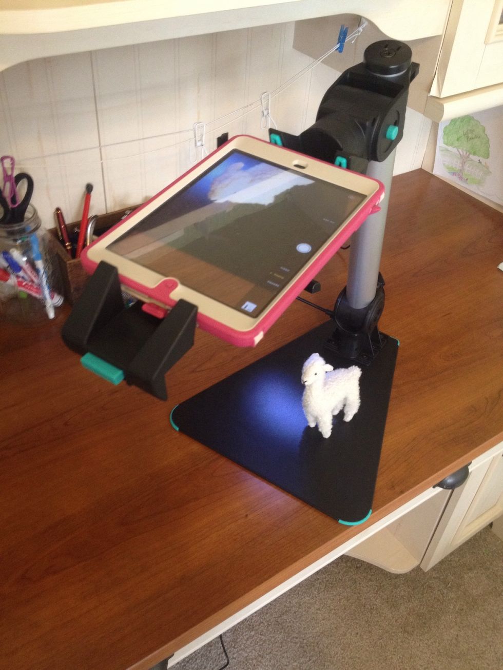 Use the Justand V2 as a document camera. You could use something like Reflector or an Apple TV to mirror your iPad to your projector.