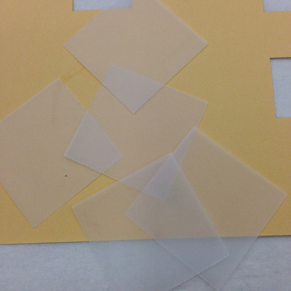 Use the larger square punch to punch windows out of the vellum paper. You may also use scissors to simply cut the squares.