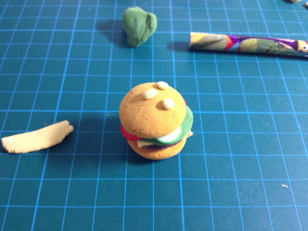- Use the light yellow clay to make some balls and glue on to make the sesames.