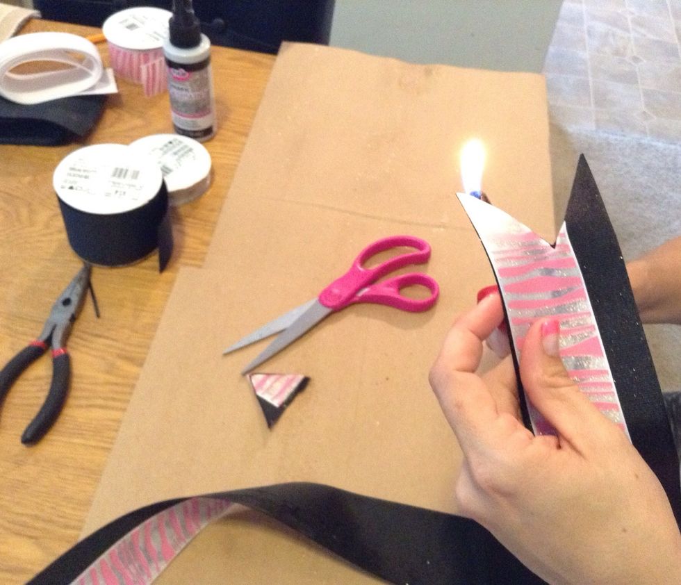 Use the lighter to seal the ribbon and prevent fraying.