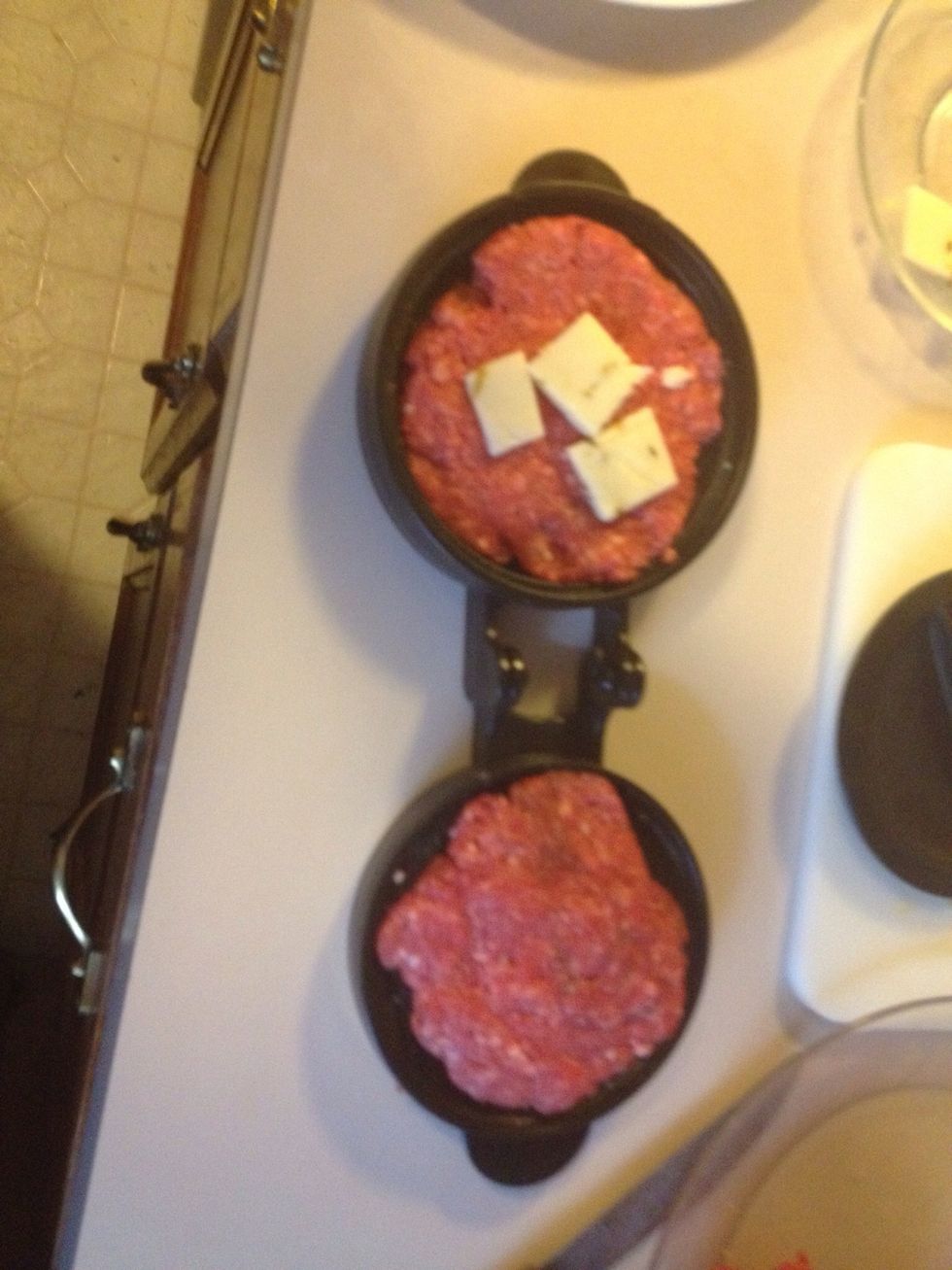 Use the little center piece of the press to make a indention to one side of the patty. Add cheese or any other filling you might have.
