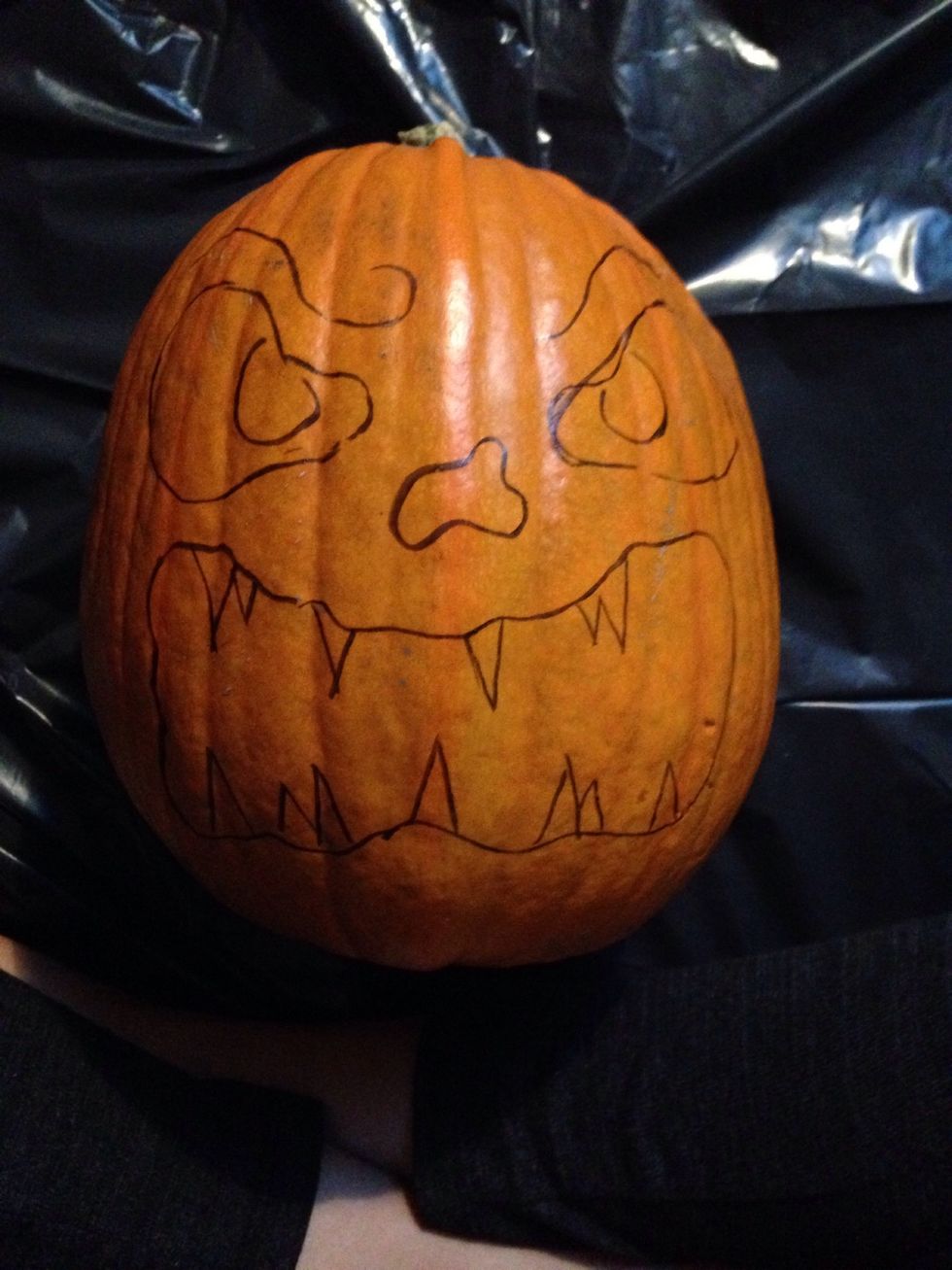 Use the marker to draw the "face" you want in your pumpkin.