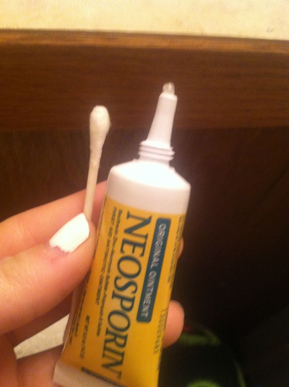 Use the neosporin and add a little bit of it onto the q-tip.